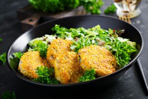 Homemade fish croquettes from white fish in cornflakes breading