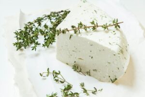 Fresh soft white cheese mozzarella with italian herbs and fresh oregano branch